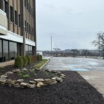 Small rock garden outside of the storage facility with a view out to the parking lot